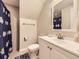 Bathroom featuring vanity sink, toilet, and shower with decorative curtain at 17404 E Prentice Cir, Centennial, CO 80015