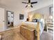 A well-lit bedroom featuring soft carpet, neutral walls and curtains, and a decorative standing mirror reflecting the room's ambiance at 17404 E Prentice Cir, Centennial, CO 80015