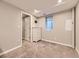 Bedroom with a white dresser, light gray carpet, small window, and neutral color walls at 17404 E Prentice Cir, Centennial, CO 80015