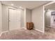 Bedroom featuring a closet with sliding doors, wood dresser, and neutral colored carpet at 17404 E Prentice Cir, Centennial, CO 80015