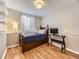 Bedroom featuring a twin bed, sleek desk, wood laminate flooring, and natural lighting at 17404 E Prentice Cir, Centennial, CO 80015