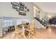 A dining area featuring hardwood floors, wooden table set, and a decorative gallery wall creating a cozy and inviting space at 17404 E Prentice Cir, Centennial, CO 80015