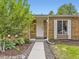 Inviting front entrance with a brick facade, well-kept landscaping, and a secure front door at 17404 E Prentice Cir, Centennial, CO 80015