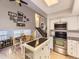 Open kitchen with an eat-in dining area, modern appliances, and a cozy staircase view at 17404 E Prentice Cir, Centennial, CO 80015