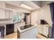 Well-lit kitchen features white cabinetry, modern appliances, and ample counter space at 17404 E Prentice Cir, Centennial, CO 80015