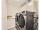 Laundry room featuring modern washer and dryer set and storage cabinets at 17404 E Prentice Cir, Centennial, CO 80015