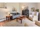 Cozy living room features stylish furniture, a patterned rug, and bright, neutral wall paint at 17404 E Prentice Cir, Centennial, CO 80015