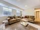 Cozy living room featuring comfortable sofas, natural light, and a stylish coffee table at 17404 E Prentice Cir, Centennial, CO 80015
