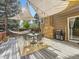 Outdoor patio featuring a dining table, grill, brick fireplace, hammock, and overhead shade at 17404 E Prentice Cir, Centennial, CO 80015