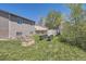Large grassy backyard with gardening containers and a storage shed, ideal for outdoor activities at 8438 Prairie Clover Way, Parker, CO 80134