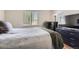 Comfortable bedroom with natural light from the window and a large dresser for ample storage at 8438 Prairie Clover Way, Parker, CO 80134