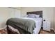 Comfortable bedroom featuring a wood-look floor, a stylish headboard, and ample closet space for storage and organization at 8438 Prairie Clover Way, Parker, CO 80134