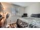 Relaxing bedroom featuring a large window with blinds, comfortable bed, and sleek, modern furniture at 8438 Prairie Clover Way, Parker, CO 80134