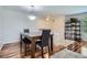 Bright dining area with wood floors, contemporary lighting, and an open layout, perfect for entertaining and casual dining at 8438 Prairie Clover Way, Parker, CO 80134