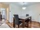 Cozy dining area featuring wood floors, a modern light fixture, and seating for Gathering meals and gatherings at 8438 Prairie Clover Way, Parker, CO 80134