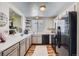 Functional kitchen featuring sleek appliances, white cabinetry, and ample counter space for meal preparation and cooking at 8438 Prairie Clover Way, Parker, CO 80134