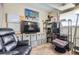 Cozy living room area with plush seating, a large TV, and ample storage for organized living at 8438 Prairie Clover Way, Parker, CO 80134