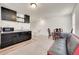 Basement kitchenette with dark cabinetry, granite countertops, and microwave at 10096 Zeno St, Commerce City, CO 80022