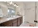 Double vanity bathroom with granite countertops and a large mirror at 10096 Zeno St, Commerce City, CO 80022