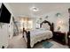 Bedroom with a dark wood bed frame, window curtains, and a small rug at 10096 Zeno St, Commerce City, CO 80022