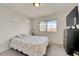 Cozy bedroom with a double bed, window, and ample natural light at 10096 Zeno St, Commerce City, CO 80022