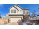 Two-story house with a beige and gray exterior, a two-car garage, and a landscaped front yard at 10096 Zeno St, Commerce City, CO 80022