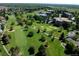 Aerial view of community featuring golf course, landscaping and building exteriors at 13631 E Marina Dr # 109, Aurora, CO 80014