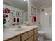 Bright bathroom with vanity, neutral finishes, framed artwork, and combined shower/tub at 13631 E Marina Dr # 109, Aurora, CO 80014