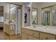 Dual sink bathroom showcasing an open doorway with sliding mirrored closet at 13631 E Marina Dr # 109, Aurora, CO 80014