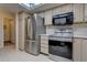 Bright kitchen featuring stainless steel appliances, white cabinetry, and ample counter space for meal preparation at 13631 E Marina Dr # 109, Aurora, CO 80014