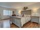 Spacious main bedroom showcasing a large window, king-size bed, and wood floors at 13631 E Marina Dr # 109, Aurora, CO 80014