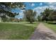 Scenic community walking path surrounded by green space, mature trees and blue sky at 13631 E Marina Dr # 109, Aurora, CO 80014