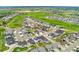 Aerial view showcases a community layout with golf course and residential area at 10968 Lewiston St, Commerce City, CO 80022