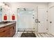 This bathroom features a glass shower with dual shower heads and a chevron-patterned floor at 10968 Lewiston St, Commerce City, CO 80022