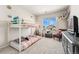 This bedroom features a bunk bed and a window that looks out to a neighborhood home at 10968 Lewiston St, Commerce City, CO 80022