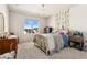 This bedroom includes a chandelier, a large window, and a patterned wall decoration at 10968 Lewiston St, Commerce City, CO 80022