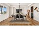 Bright dining room with wood floors, modern chandelier, and large window showcasing natural light at 10968 Lewiston St, Commerce City, CO 80022