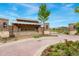 Stone entrance to the Gallery community with sign, trees, and well-maintained landscaping at 10968 Lewiston St, Commerce City, CO 80022
