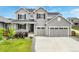 Charming two-story home featuring a covered porch, well-maintained lawn, and a spacious two-car garage at 10968 Lewiston St, Commerce City, CO 80022
