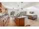 Bright, spacious kitchen featuring an island, wooden floors, and stainless steel appliances at 10968 Lewiston St, Commerce City, CO 80022
