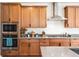 Close up of the kitchen showing stainless steel appliances, and maple cabinets at 10968 Lewiston St, Commerce City, CO 80022