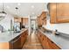 Modern kitchen with stainless appliances, maple cabinets and center island at 10968 Lewiston St, Commerce City, CO 80022