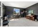 A flex room with black walls, carpet, a piano, and natural light from the window at 10968 Lewiston St, Commerce City, CO 80022