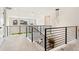 Second story hallway with minimalist railing and light fixture at 10968 Lewiston St, Commerce City, CO 80022