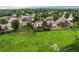 Aerial view of the home with the backyard, fence and open space and neighborhood at 10137 W Berry Dr, Littleton, CO 80127
