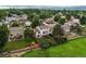 Areal view showcasing a fenced backyard with a deck, mature trees, and lush green grass at 10137 W Berry Dr, Littleton, CO 80127