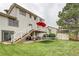 Spacious backyard featuring a deck with stairs, patio, trampoline, shed, and well-maintained lawn at 10137 W Berry Dr, Littleton, CO 80127