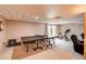 Basement with a ping pong table, exercise bike, and seating area at 10137 W Berry Dr, Littleton, CO 80127