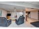 Spacious basement area features a television, seating, and access to a stairwell at 10137 W Berry Dr, Littleton, CO 80127