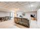 Finished basement with a lounge area, ping pong table, and access to the outside at 10137 W Berry Dr, Littleton, CO 80127